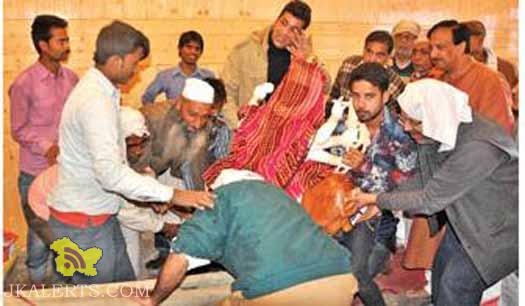 Muslim man helps in Murti Astapan prayers at a temple in Srinagar
